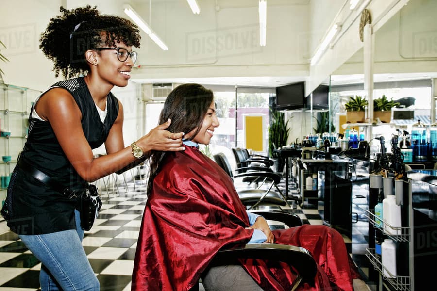 A stylist finishing a client's hair at Bangs Salon